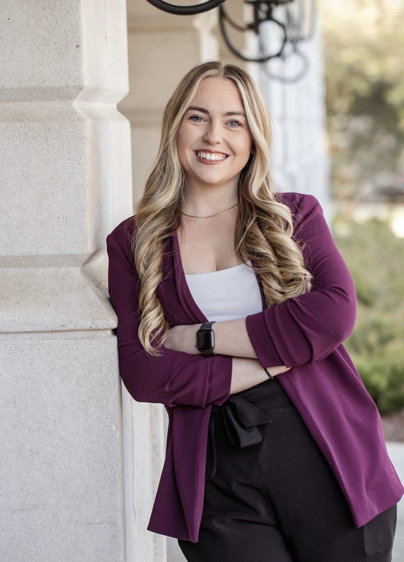Sam Palmieri, real estate broker, smiling with arms crossed